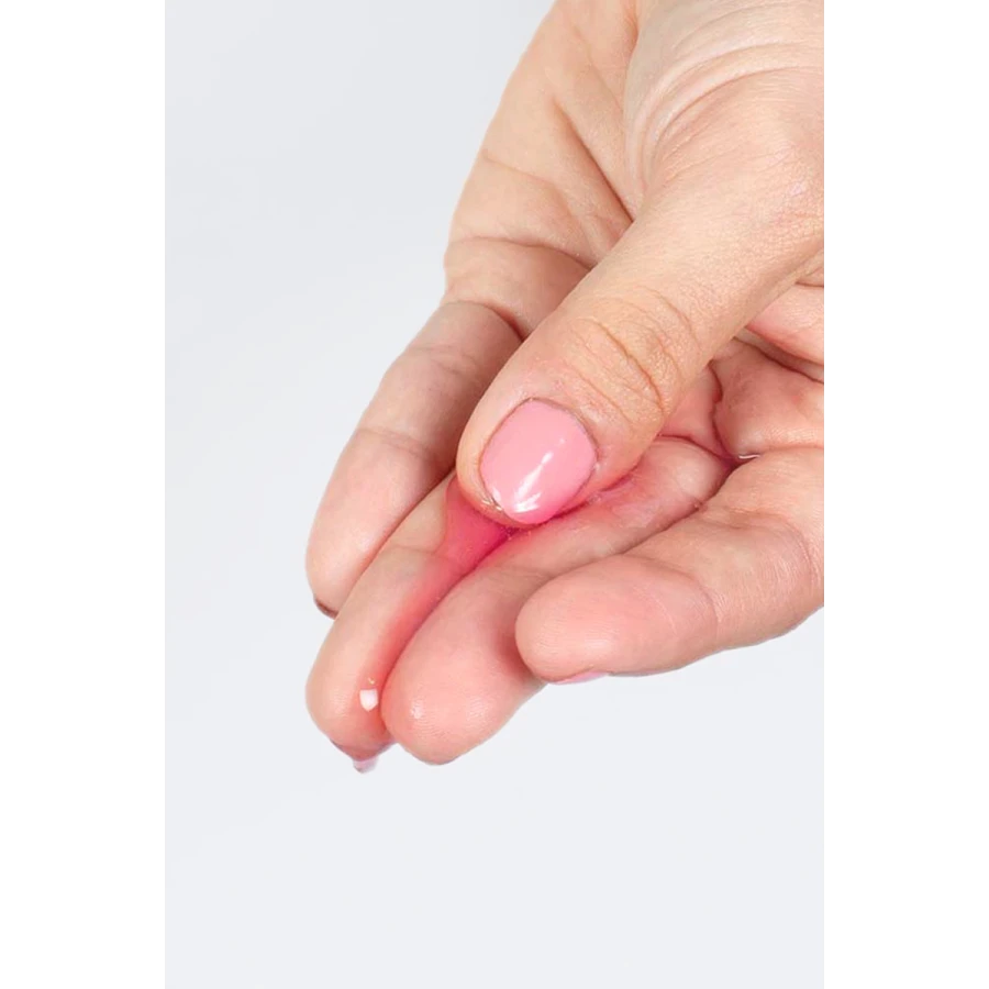 Goutte de lubrifiant Secret Play transparent sur le bout du doigt, texture gel pour massage et intimité